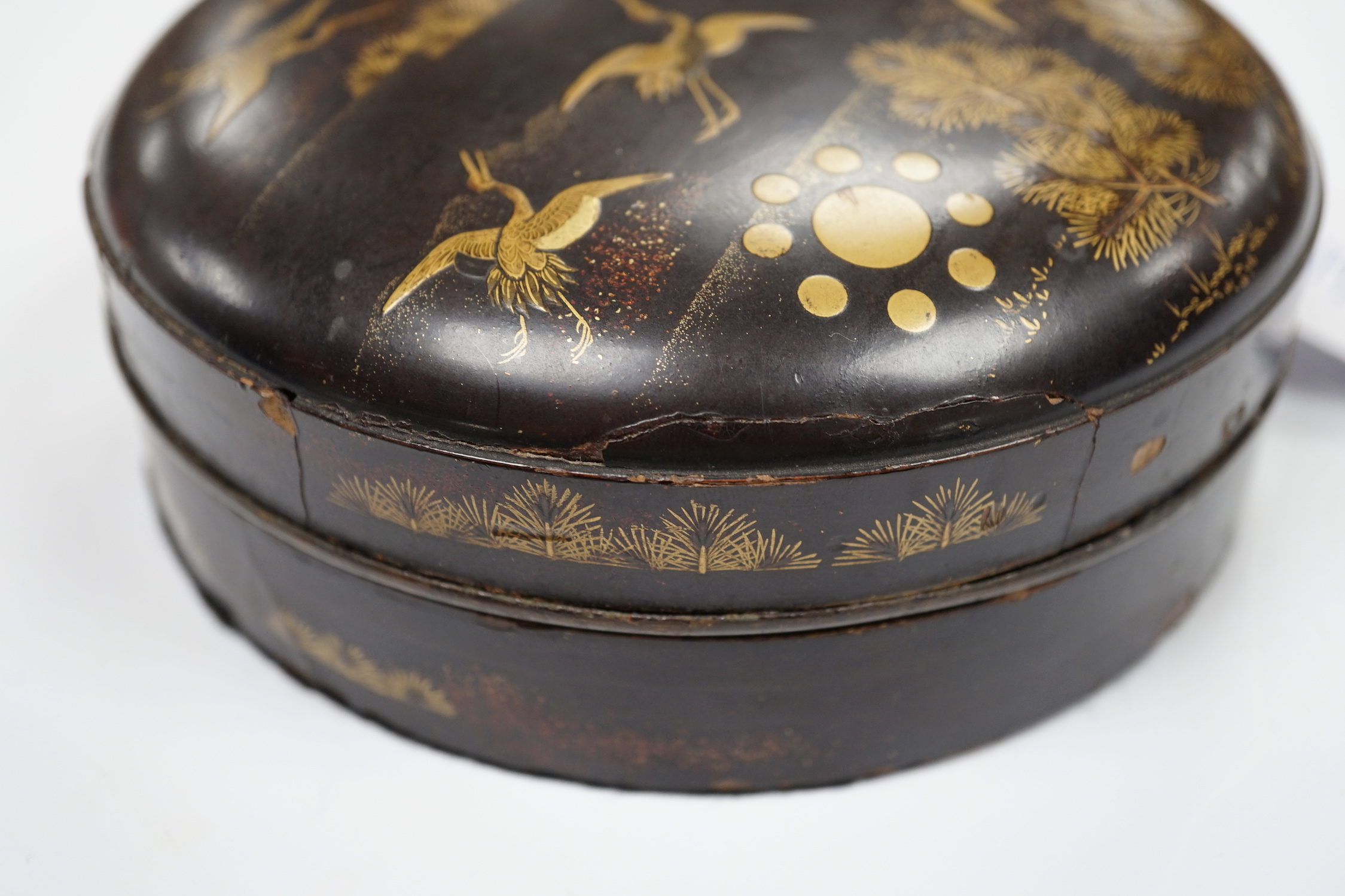 A Japanese cast mirror, housed in a lacquered case, 12cm in diameter